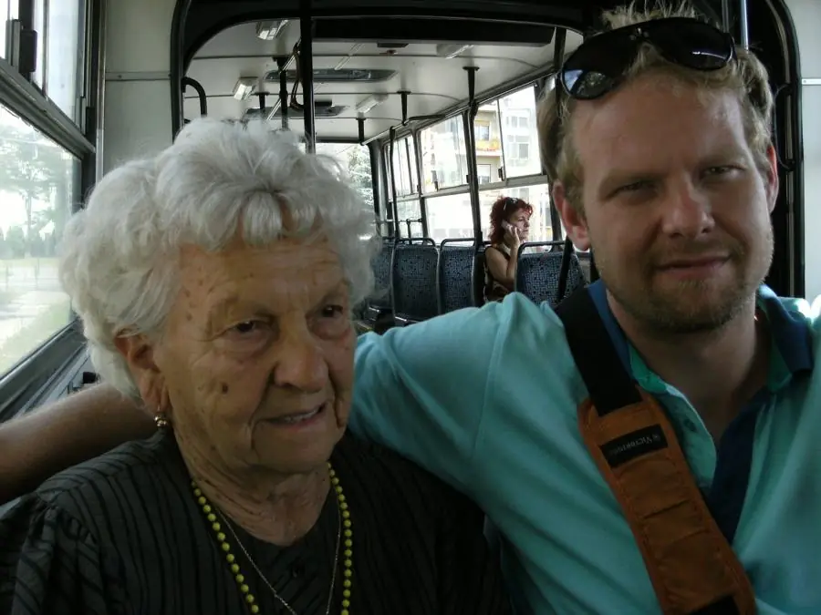 Grandma and me sitting close together on a city bus
